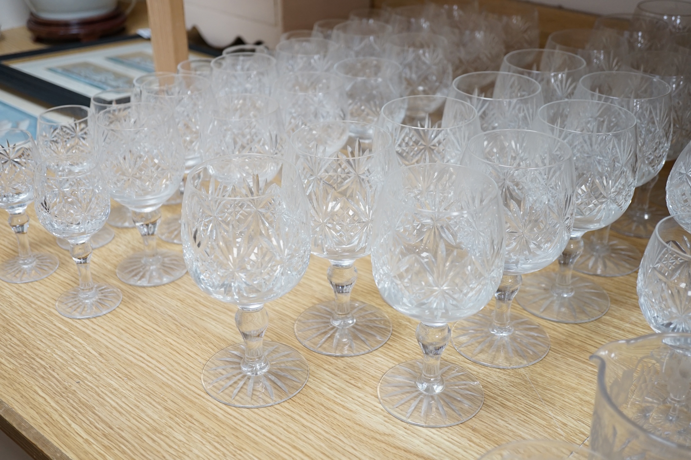 Various suites of star cut Thomas Webb drinking glasses, together with three decanters, pair of whisky tumblers and jug, five tumblers and three engraved Aston Villa champagne flutes, (approx. 89 items)